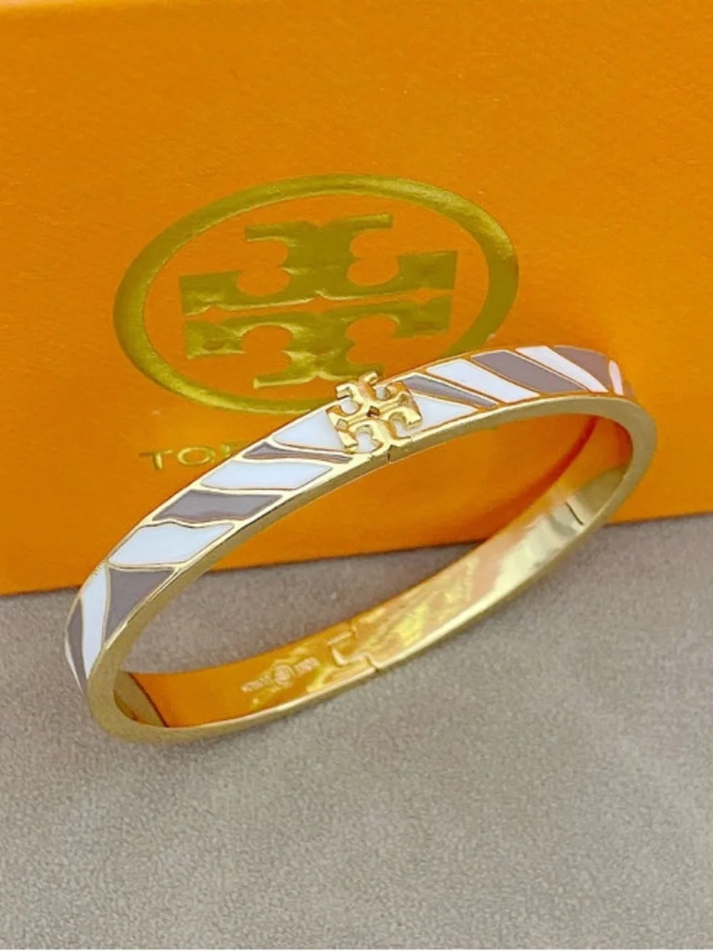 Tory Burch Gold Bracelet with White and Light Gray Enamel Stripes